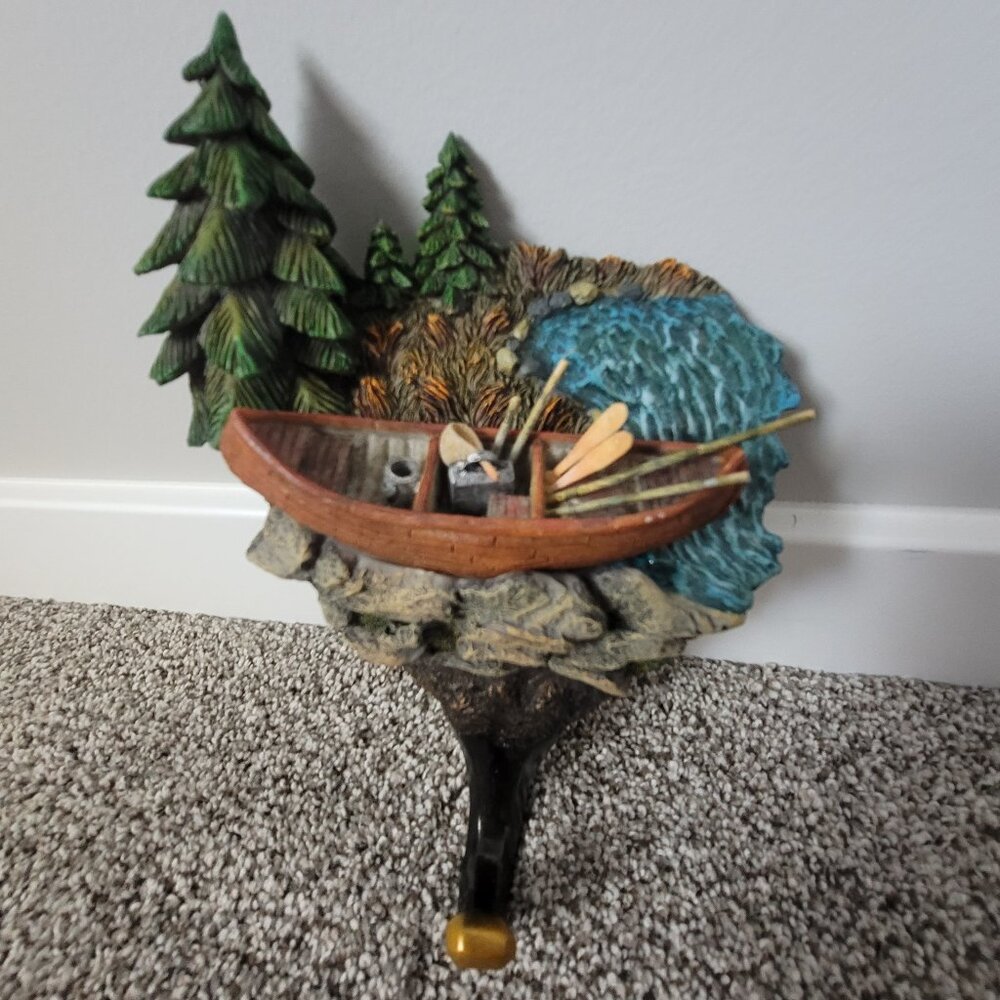 Wall hanger decor. Cabin and canoe